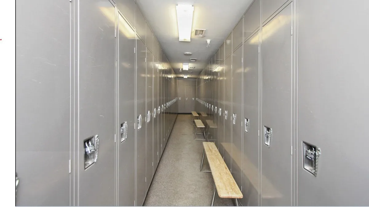 A well-appointed ski locker room featuring rows of lockers and benches, designed for guests to easily store their ski and snowboarding gear. The space is clean, organized, and evokes the anticipation of hitting the slopes or returning from adventure.